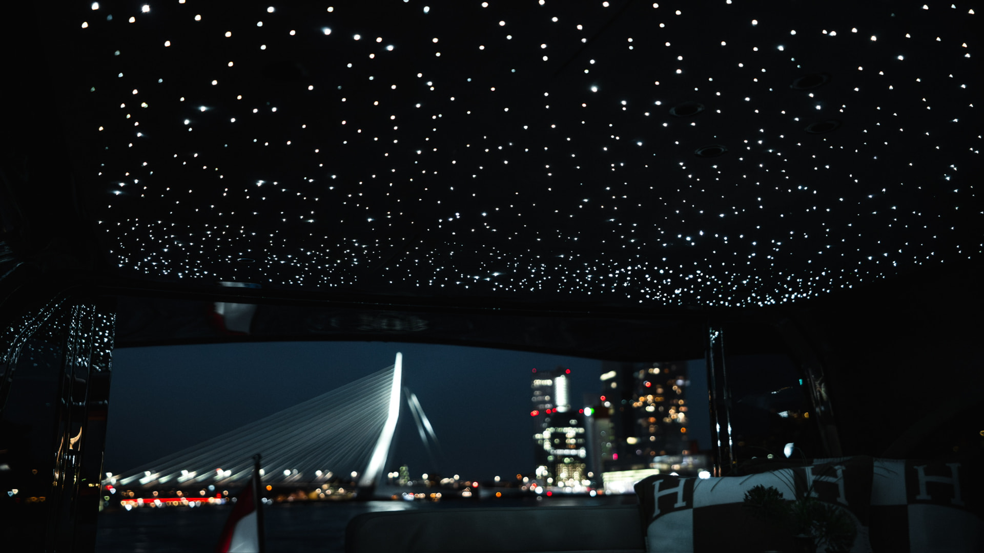 Starlight headliner on deck with city lights beyond