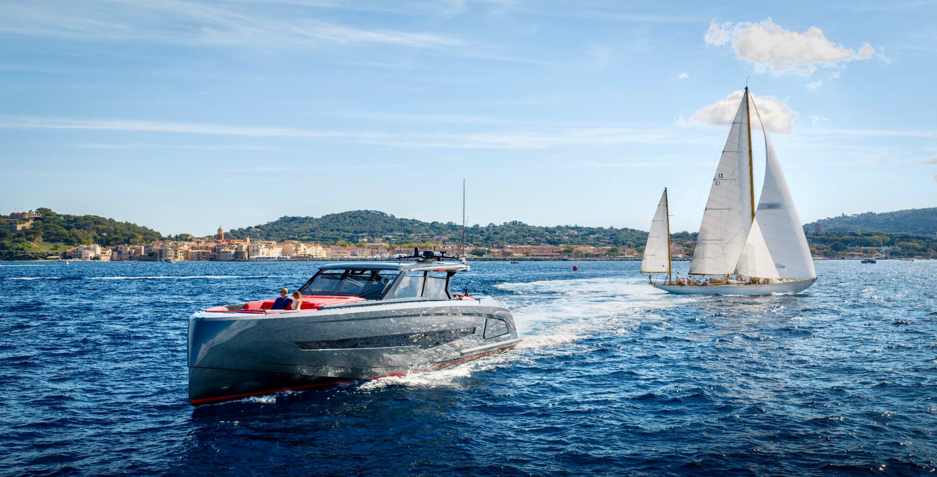 Tender passing a classic sailing yacht off Saint-Tropez